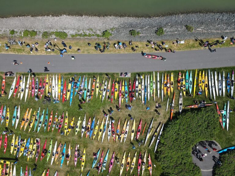 A multitude of multicolored sea kayaks cover the grass at Zuanich Point Park for Ski to Sea.