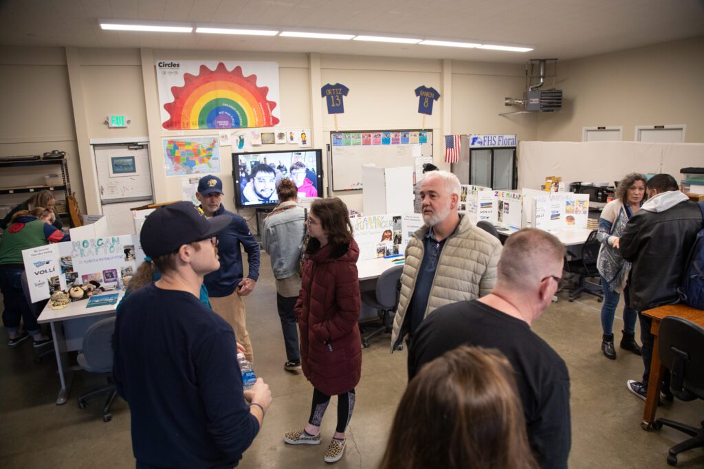 Community Transitions student Gabbey and dad Derick Krutsinger speak with other visitors at the open house for the new facility.