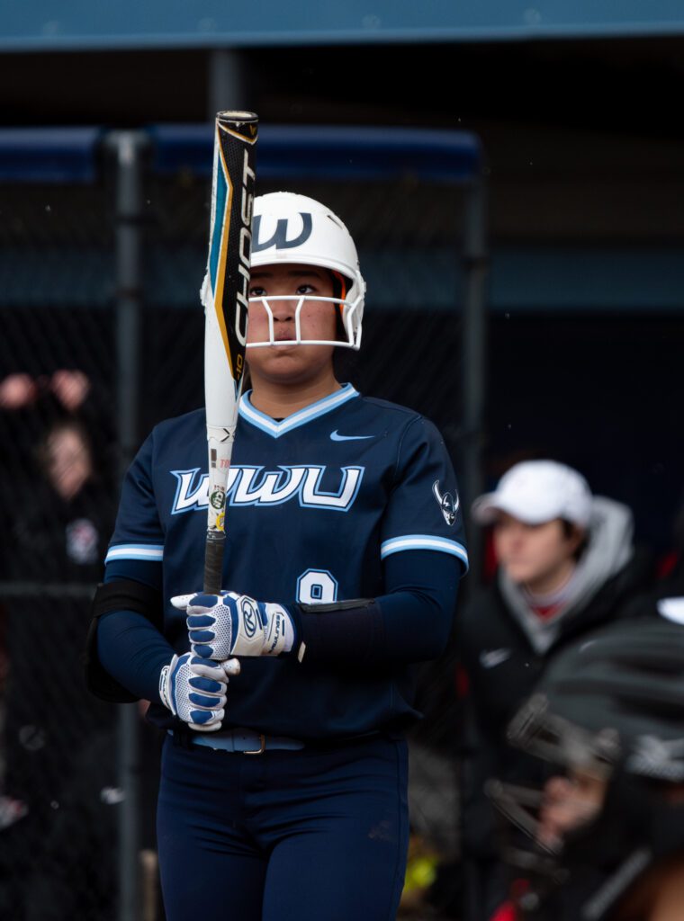 Western freshman pitcher Kaiana Kong looks at her bat before stepping back into the box.