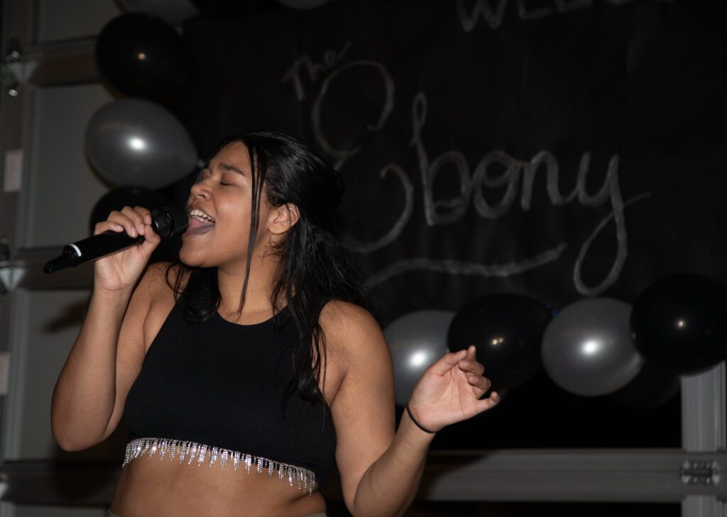 Ebony Harris, a local artist, belts an original song to gala attendees.