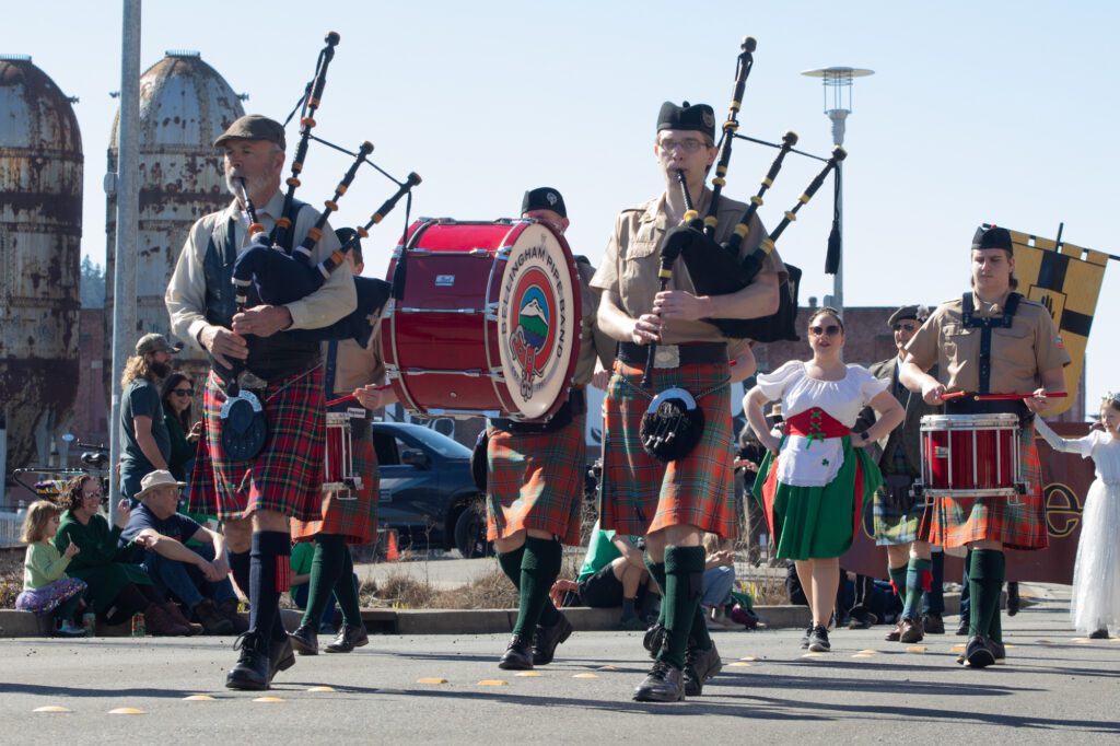 The Bellingham Pipe Band members plays bagpipe music as they march through the parade.
