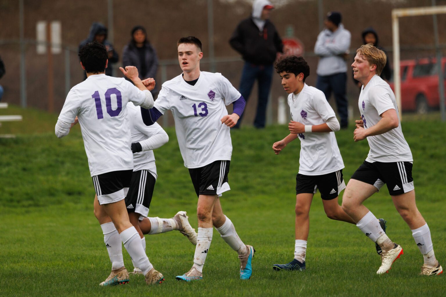 Nooksack Valley's Isaac Lind (13) gets a fist bump from teammate Evan Bravo on Monday, March 25 after scoring the first goal for the Pioneers in a 2-0 road win over Mount Baker.