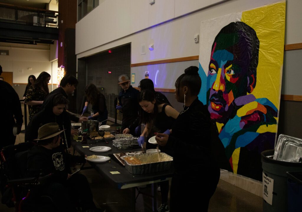 A portrait of Martin Luther King Jr. stood behind the food table.