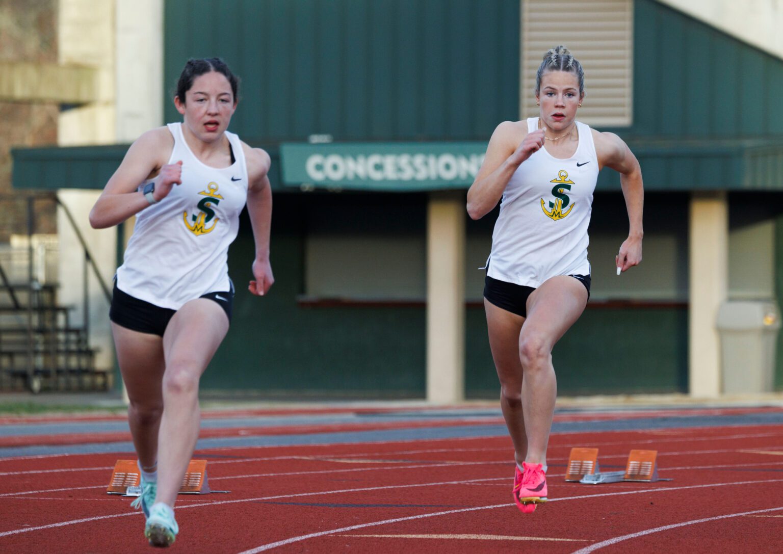 Sehome’s Tryia Mitchell, right, and teammate Keira Reeves take off from the starting blocks in the girls 200-meter dash Wednesday, March 13 during a tri-meet with Sehome and Squalicum at Civic Stadium.