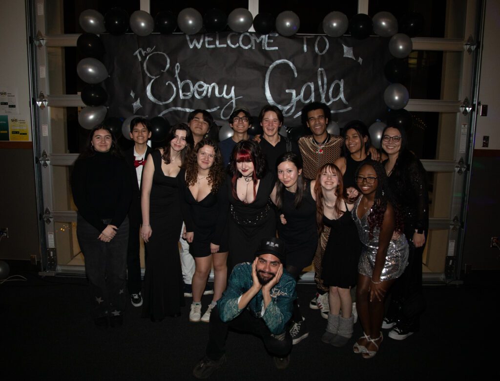 Members of the Young Multiracial Society and the performers pose for a photo at the end of the night.