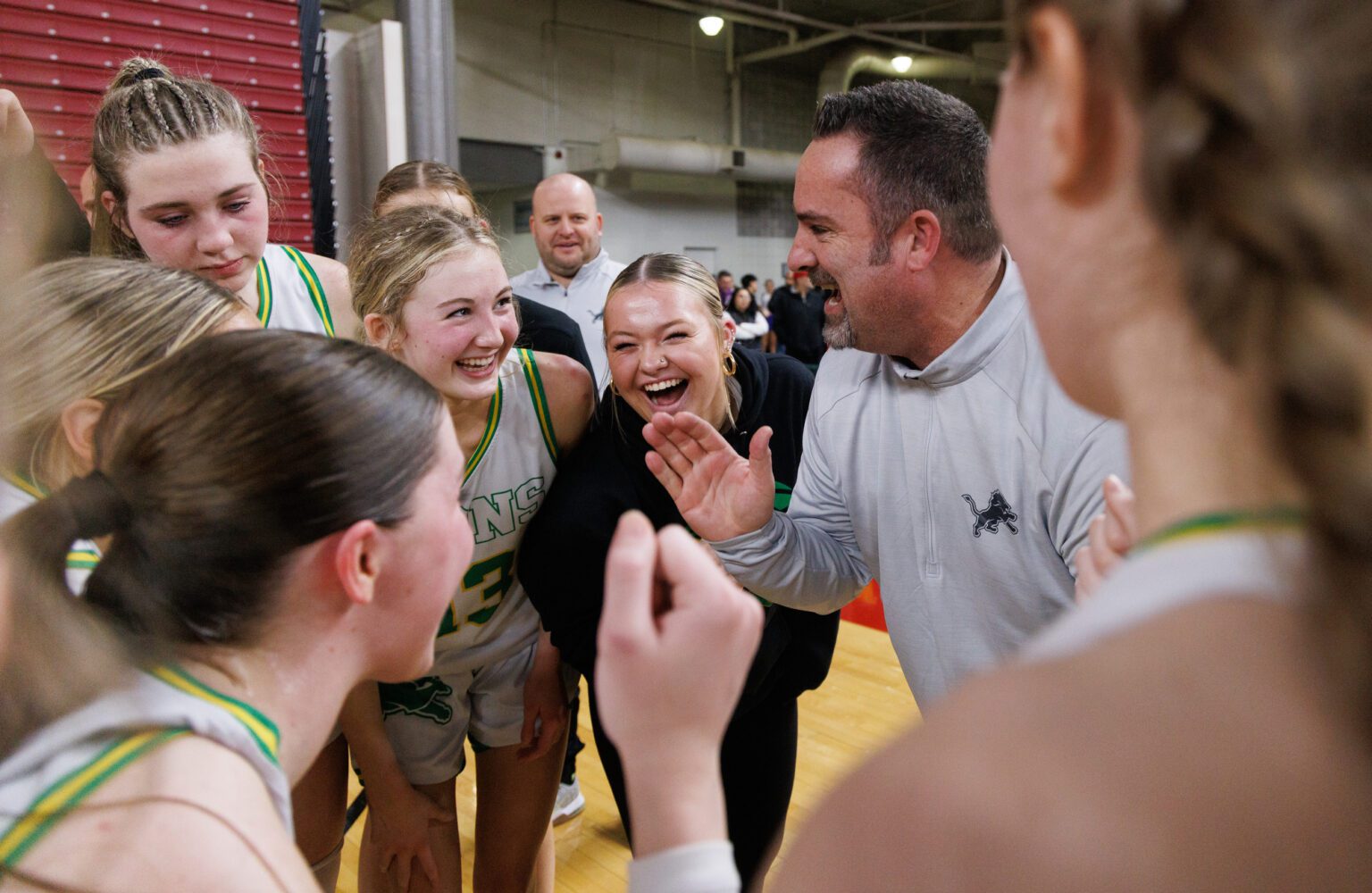Lynden head coach Rob Adams and his team celebrate after beating Clarkston in the semifinals.