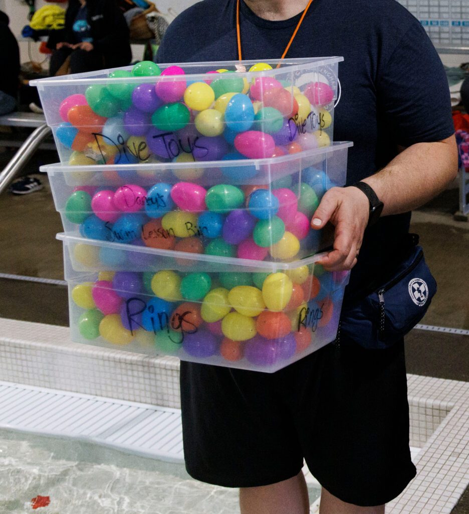 Totes filled with plastic eggs are ready for throwing into the water.
