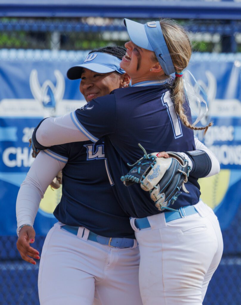 Western's Maleah Andrews, left, gets a hug from teammate Hailey Rath March 30 after turning a double play to end the inning against Saint Martin's.