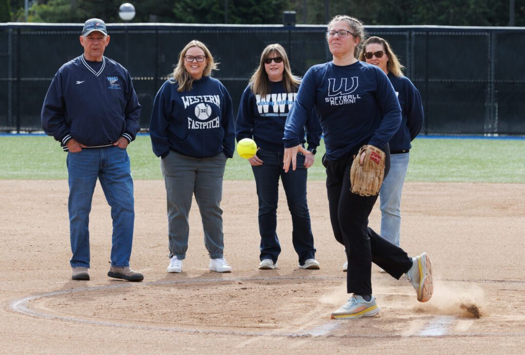 Western alum Alison Haukass Richards throws out the first pitch with teammates from the Vikings' 1998 NAIA National Championship team.