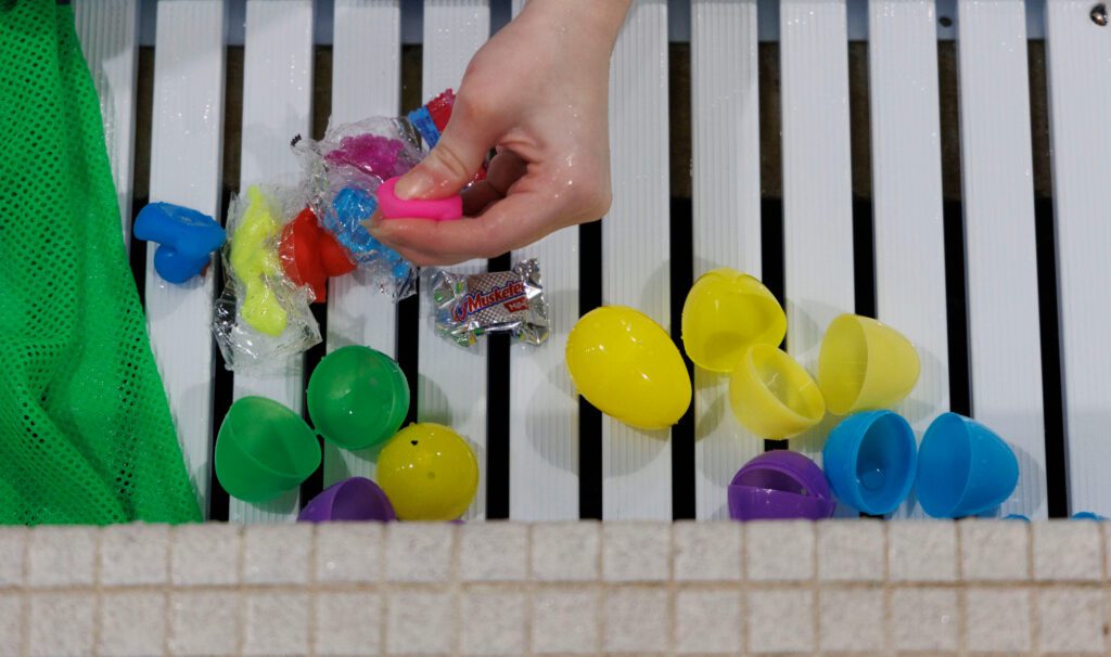 Eggs and contents are separated poolside after the egg hunt.