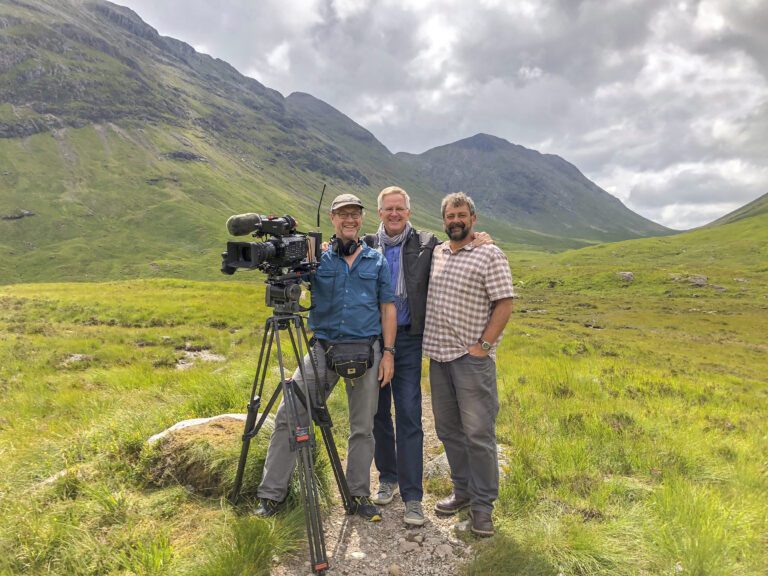 Rick Steves, center, and his film crew in the Scottish Highlands.