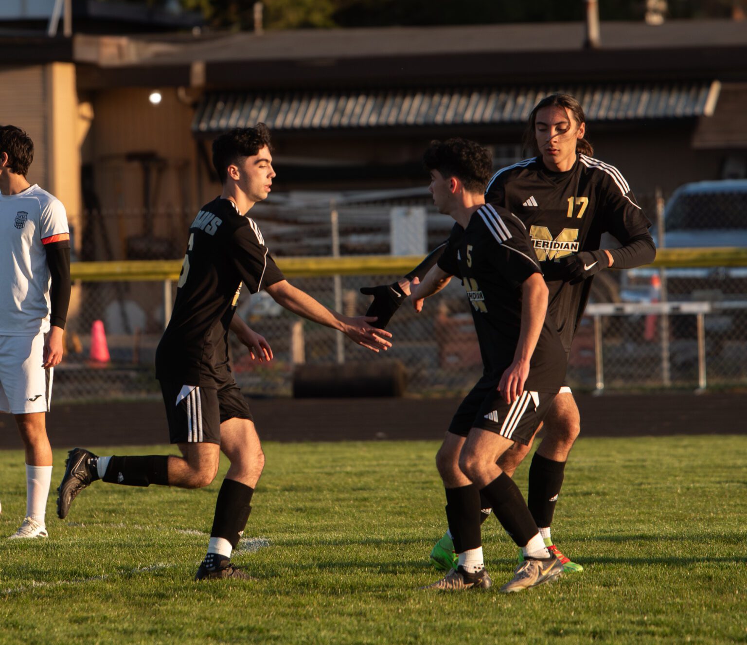 Meridian junior defender Kellen Todd gets high-fives Thursday, April 3 from teammates after scoring the first goal of the game against Blaine. The Trojans scored once in the first half, second half and stoppage time to beat the Borderites 3-0.