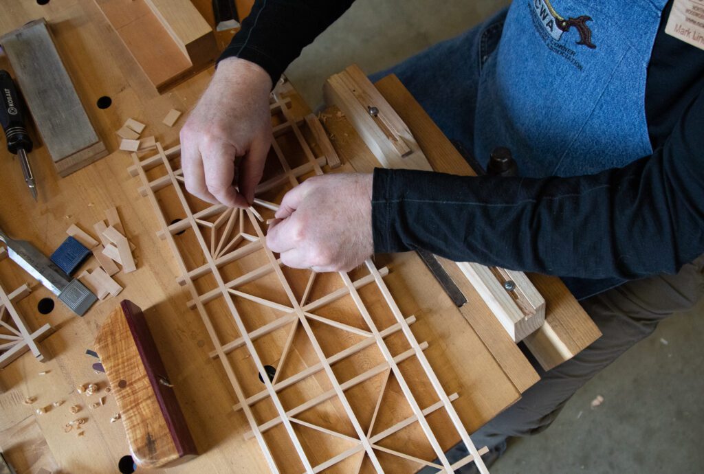 Mark Lindenbaum of Northwest Corner Woodworking Association creates a pattern of triangles and rectangles with small pieces of wood. Kumiko is a Japanese-type of woodworking that doesn't require nails and results in intricate geometric patterns.