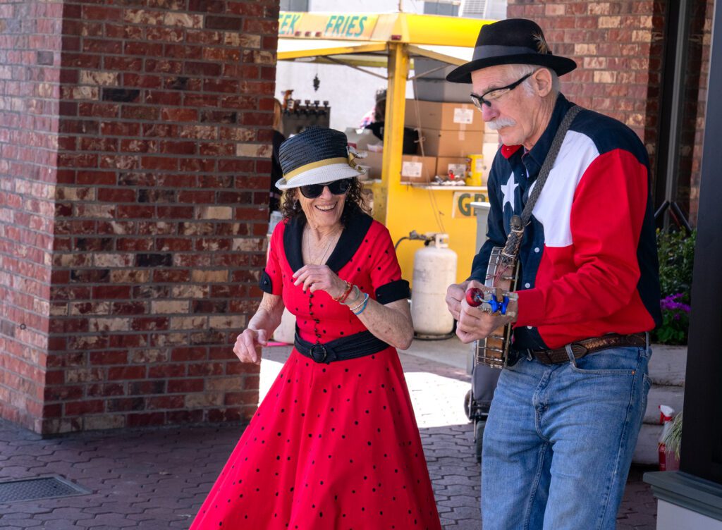 A pair of street performers drew a crowd as they sang and danced to folk songs.