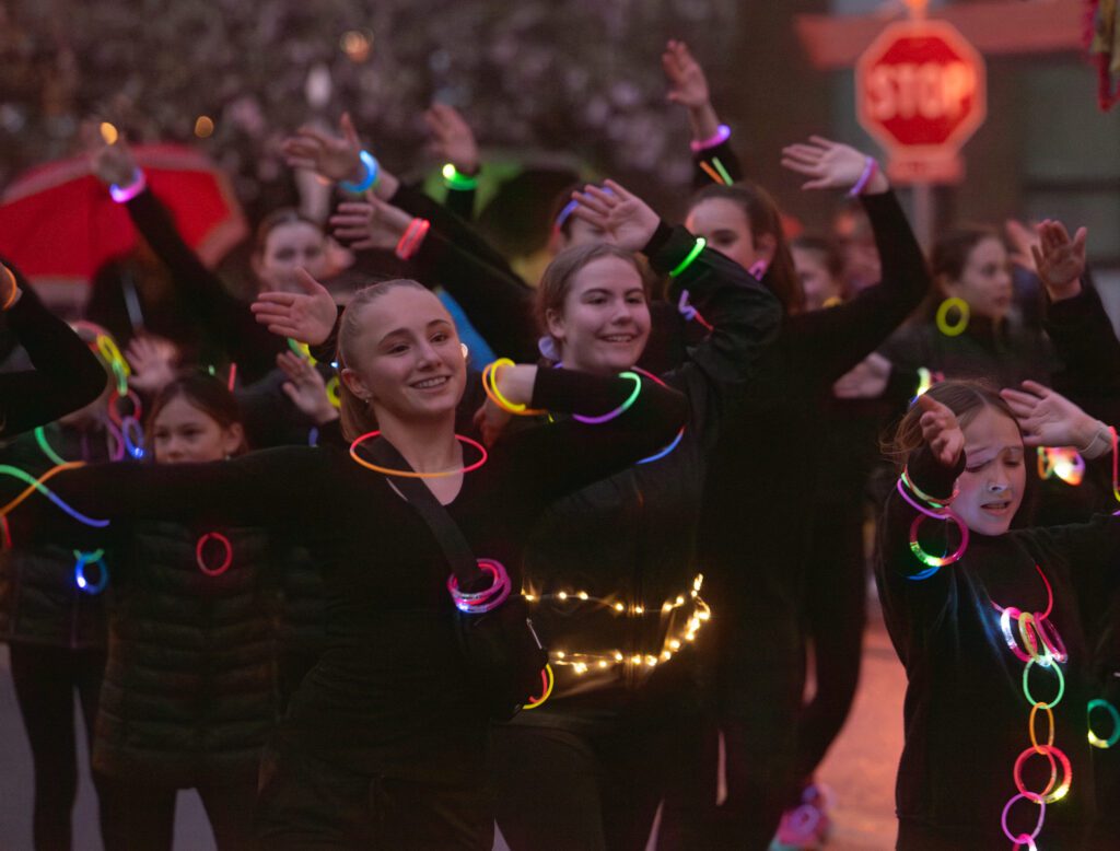 A dance group wears glow sticks in the parade.