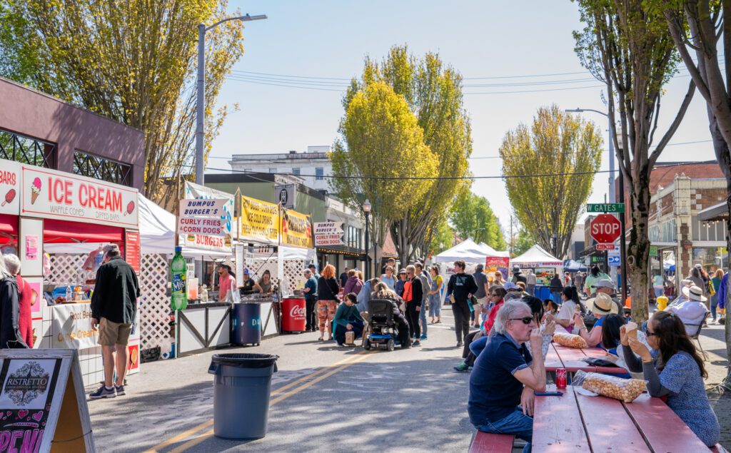 Visitors to the Tulip Festival Street Fair on Friday, April 19 in Mount Vernon eat traditional carnival foods from corn dogs to caramel corn.