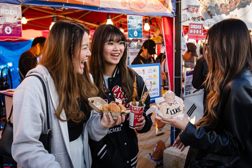 Ocean Lo, Jamie Lam and Getty Li sample street foods including dessert bao and egg waffles.