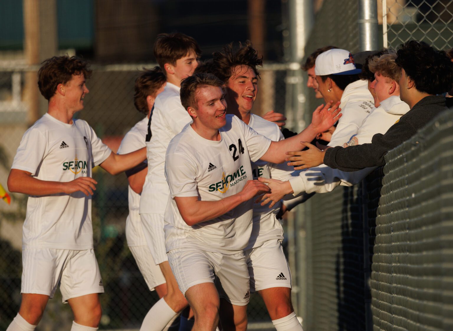Sehome's Noah Allen (24) high-fives fans Monday, April 15 after scoring the first goal of a 3-0 road win over Bellingham.