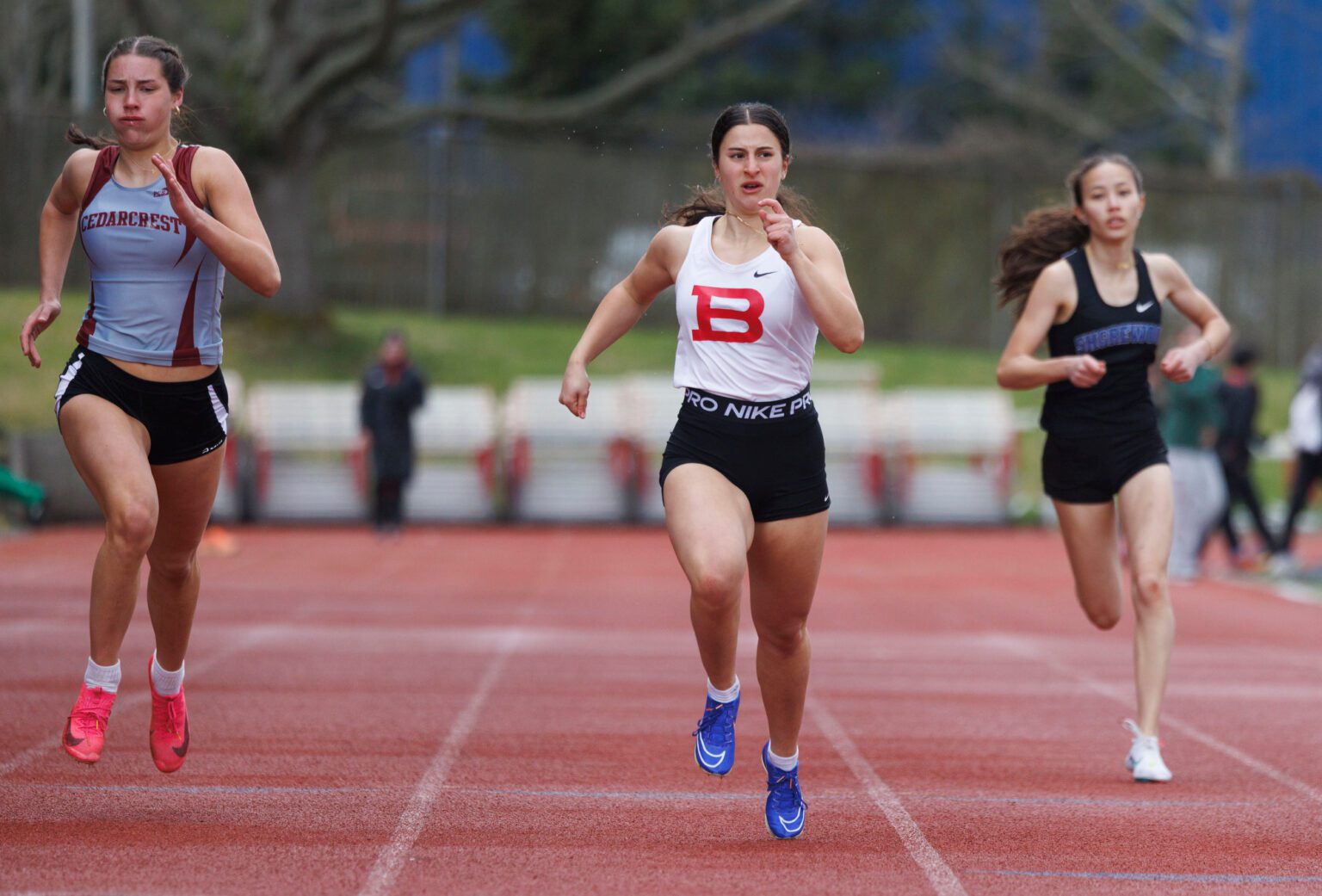 Bellingham's Sofia Calabretta looks over at the timer Saturday, April 6 as she crosses the finish line of the 200-meter dash during the Birger Solberg Invitational at Civic Stadium.