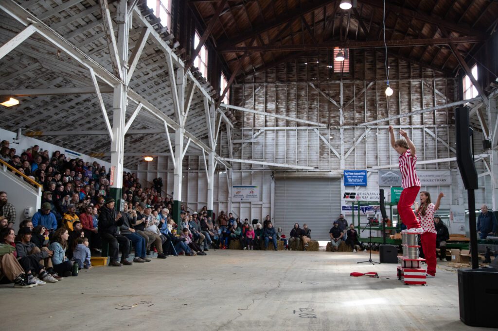 Miles Freelan and Taryn Mindt of Bellingham perform balancing tricks in the barn at the Skagit County Fairgrounds.