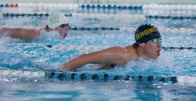 Sehome's Scotty Li leads the 100-yard butterfly as another swimmer trails right behind him.